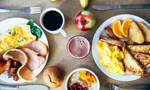 Vibrant breakfast with eggs, fruits, toast, and coffee for a wholesome start.