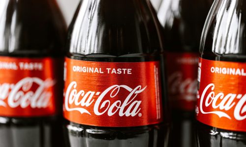 Close-up shot of Coca-Cola bottles highlighting the iconic red label and branding.